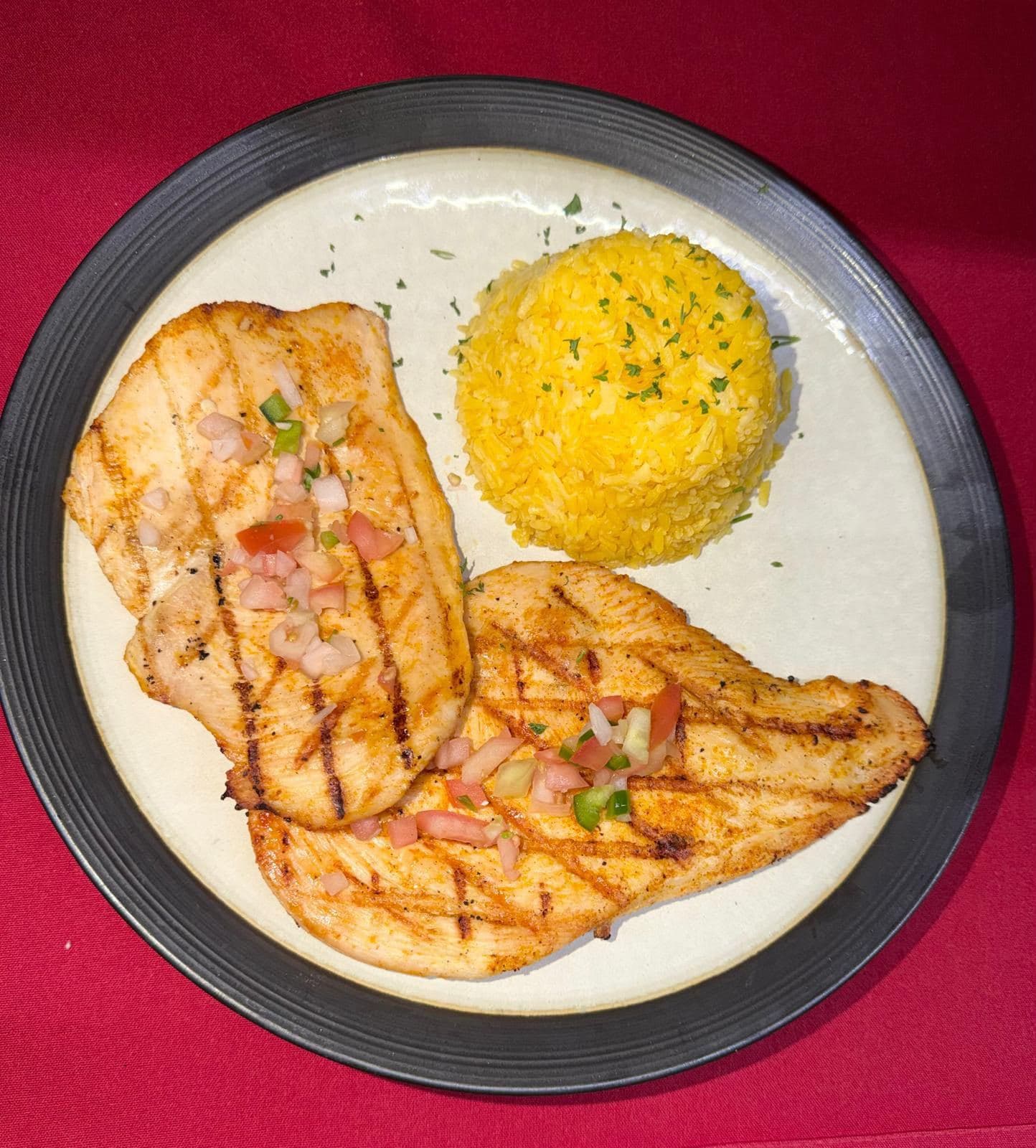 Grilled chicken breasts with pico de gallo and yellow rice