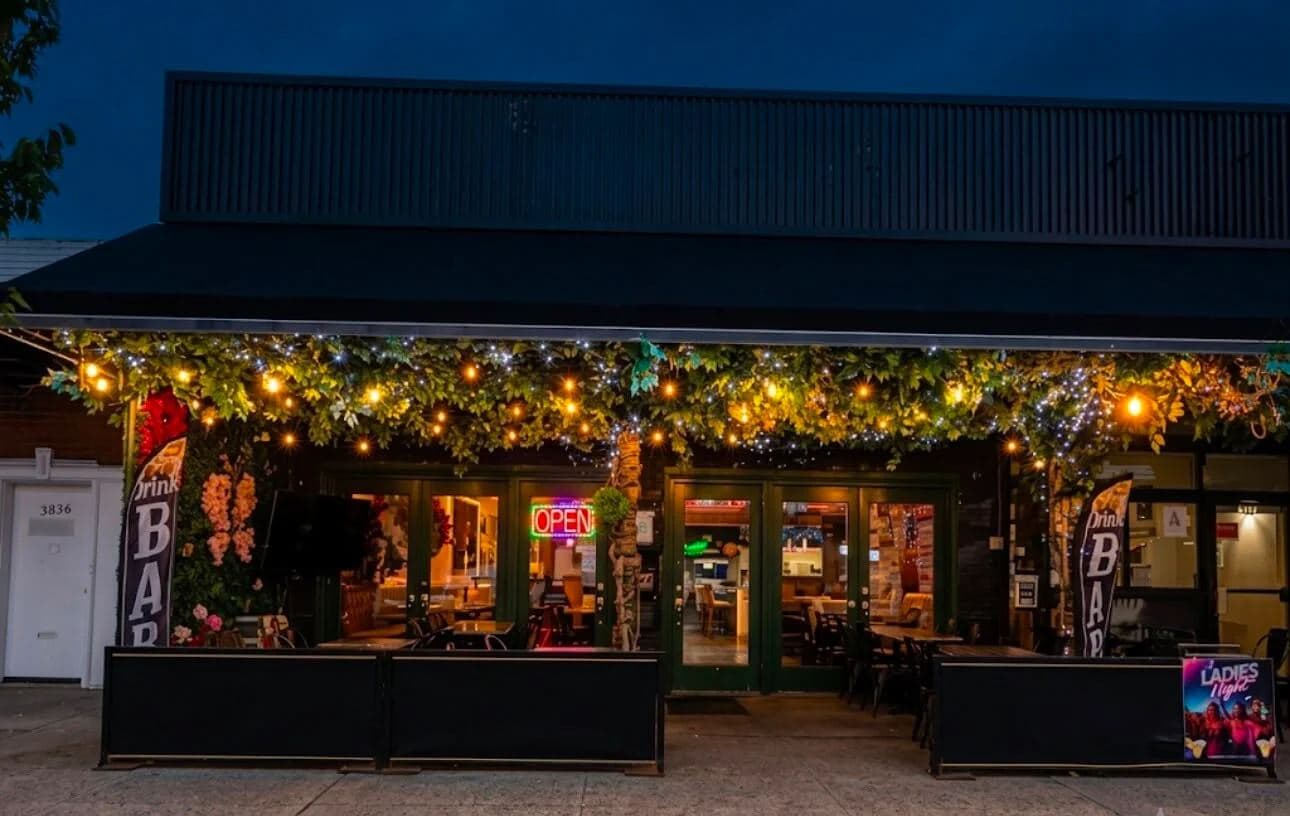 The front of Travesias at dusk, lit with string lights